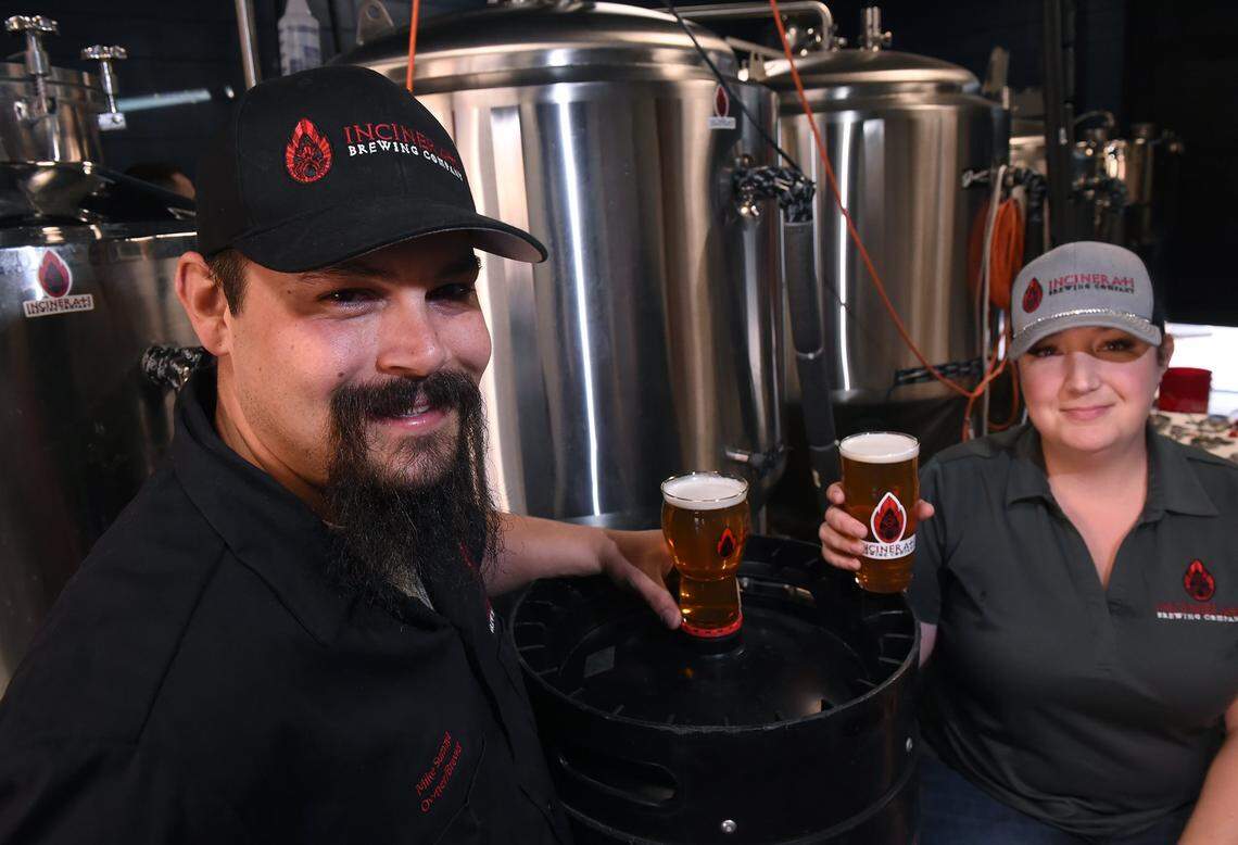 Mike Sumaya, left, and his wife Natalie Sumaya, pictured in this Fresno Bee file photo from 2019, own Incinerati Brewing Company.  