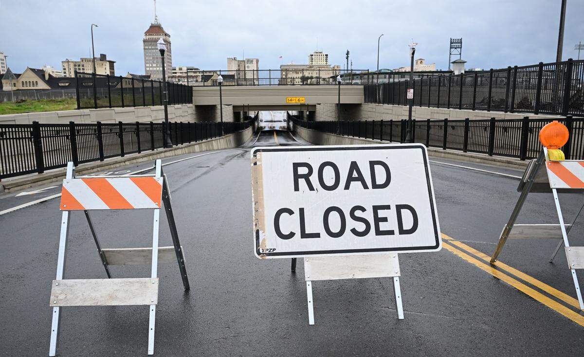 Tulare Street at the high-speed rail crossing is closed due to flooding after heavy thunderstorms and winds Wednesday morning, Dec. 24, 2025 in Fresno.