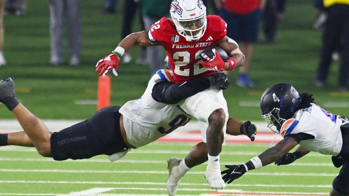 Fresno State running back Malik Sherrod, center, tries to find an opening between Boise State’s Ahmed Hassanein, left, and Rodney Robinson, right, in the Battle of the Milk Can Saturday, Nov. 4, 2023 in Fresno.