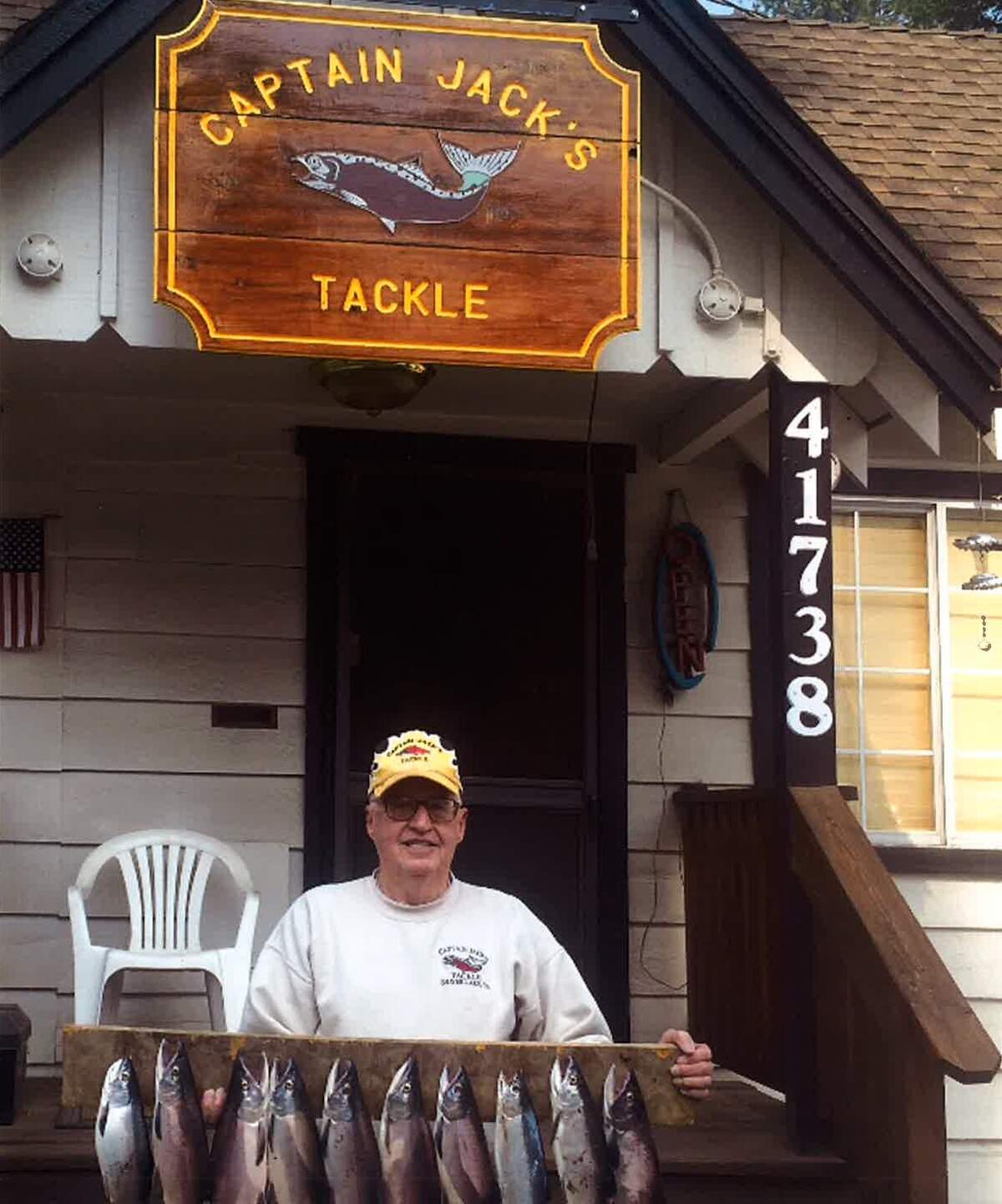 Jack Yandell outside his Shaver Lake shop, Captain Jack’s Tackle, holding a string of kokanee salmon.