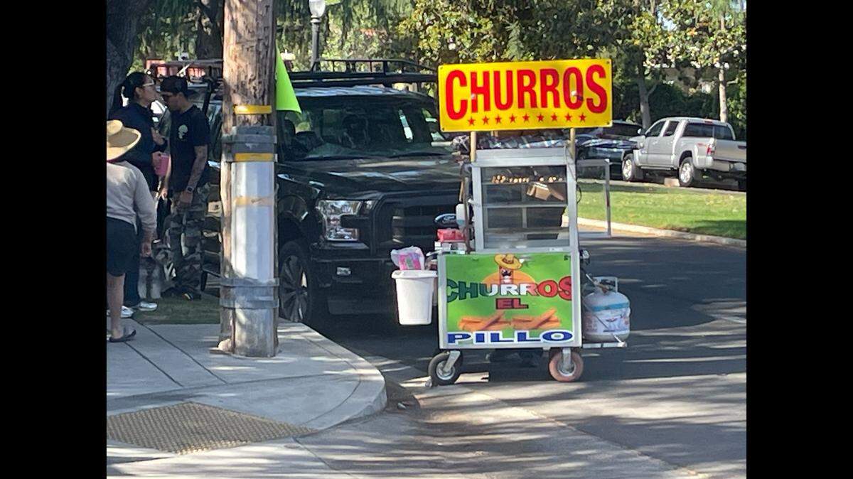 Fresno City Attorney Andrew Janz said code enforcement officers are working to ensure that food vendors, like this cart on Terrace Avenue Saturday, have the proper permits at yard sales in the Fresno High district.