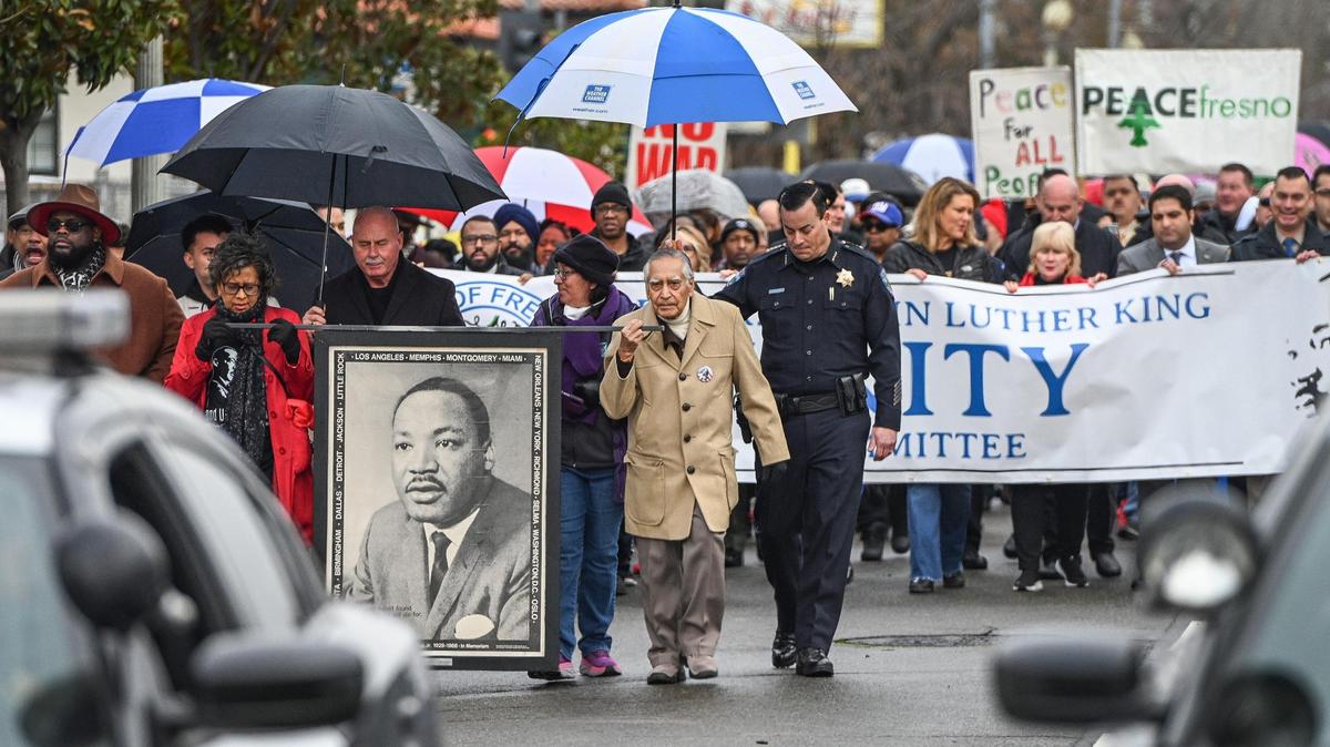 Dr. Sudarshan Kapoor, center, helps lead the 39th annual Martin Luther King Jr Day March from Fresno City Hall to the Fresno Veterans Memorial Auditorium in 2023.