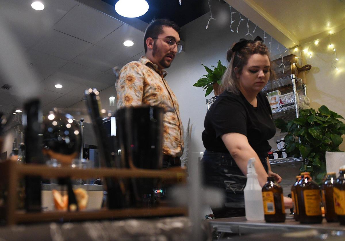 Co-owners Ian Landis, left, and Briena Poulter, right, prepare stock at Bone Dry Sober Bar, located inside Fig & Honey at a popup during Art Hop Thursday, Dec. 2, 2021 in Fresno.