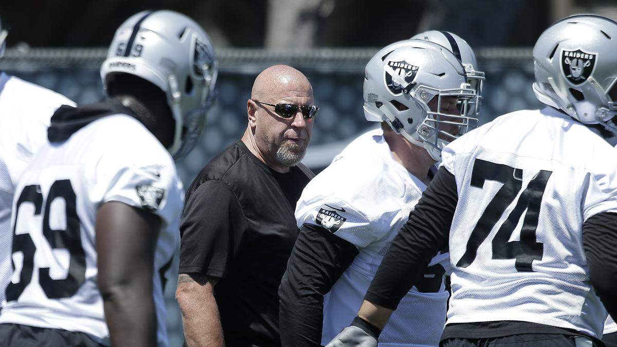 Oakland Raiders offensive line coach Tom Cable calls out instructions at the team's minicamp in Alameda, Calif. Nearly eight years after being fired as Raiders head coach, Cable is back with the team as offensive line coach.