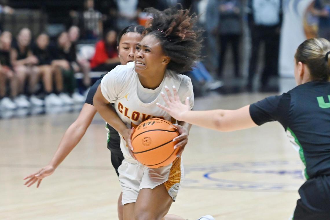 Clovis West’s Athena Tomlinson, center, drives between St. Joseph’s Annalyssa Cota, background, and Gaby Gimeno, right, in the Division I basketball championship Saturday, Feb. 24, 2024 at Selland Arena in Fresno.