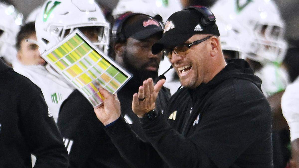 Fresno State head coach Matt Entz is seen clapping from the sidelines for a play against Utah State Saturday, Nov. 22, 2025 in Fresno. Fresno State led 17-7 at halftime.