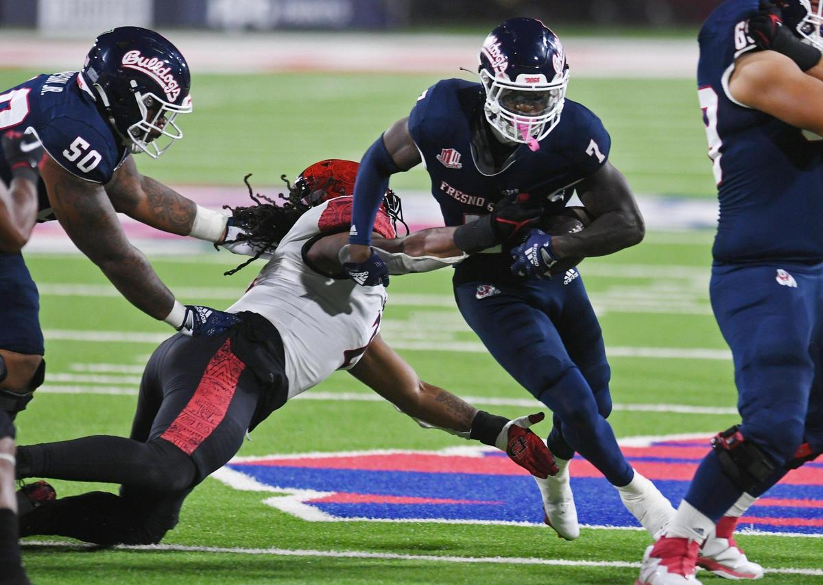 Fresno State’s Jordan Mims, right, with San Diego State’s Keshawn Banks, left, Saturday, Oct. 29, 2022 in Fresno.