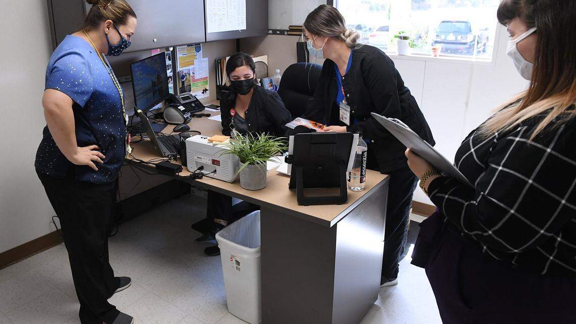 The COVID team debriefs at Central Valley Indian Health Inc. following a morning clinic Wednesday, April 21, 2021 in Clovis.