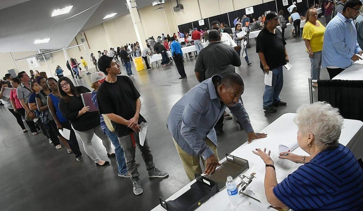 People wait in line at the annual Big Fresno Fair job fair, Thursday morning, Aug. 10, 2017, applying for 500 positions, including parking and ticket sellers, ticket takers, parking attendants, customer service representatives, maintenance staff, security guard, concessions, museum docents and more. The Big Fresno Fair runs Oct. 4-15.