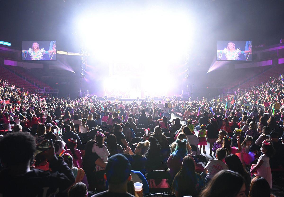 Stage lights flood the arena as Jojo Siwa performs in concert at the Save Mart Center as part of her D.R.E.A.M. The Tour Thursday, Jan. 20, 2022 in Fresno. The concert is an example of an indoor “mega-event” with more than 1,000 in attendance at which unvaccinated people would be expected wear a face mask to hinder the spread of COVID-19.