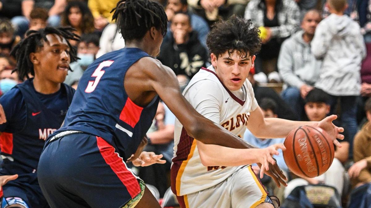 Clovis West’s Issac Martinez, right drives along the baseline against Modesto Christian (player unidentified, not on roster) during their NorCal Open Division boys basketball semifinal at Clovis West on Saturday, March 5, 2022.