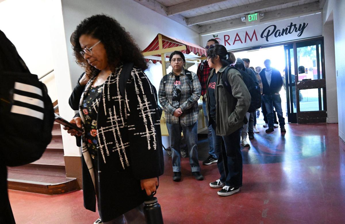 Students stand in line for Fresno City College’s Ram Pantry Monday, Jan. 13, 2025 in Fresno. Ram Pantry is a free food assistance program for students currently enrolled at Fresno City College.