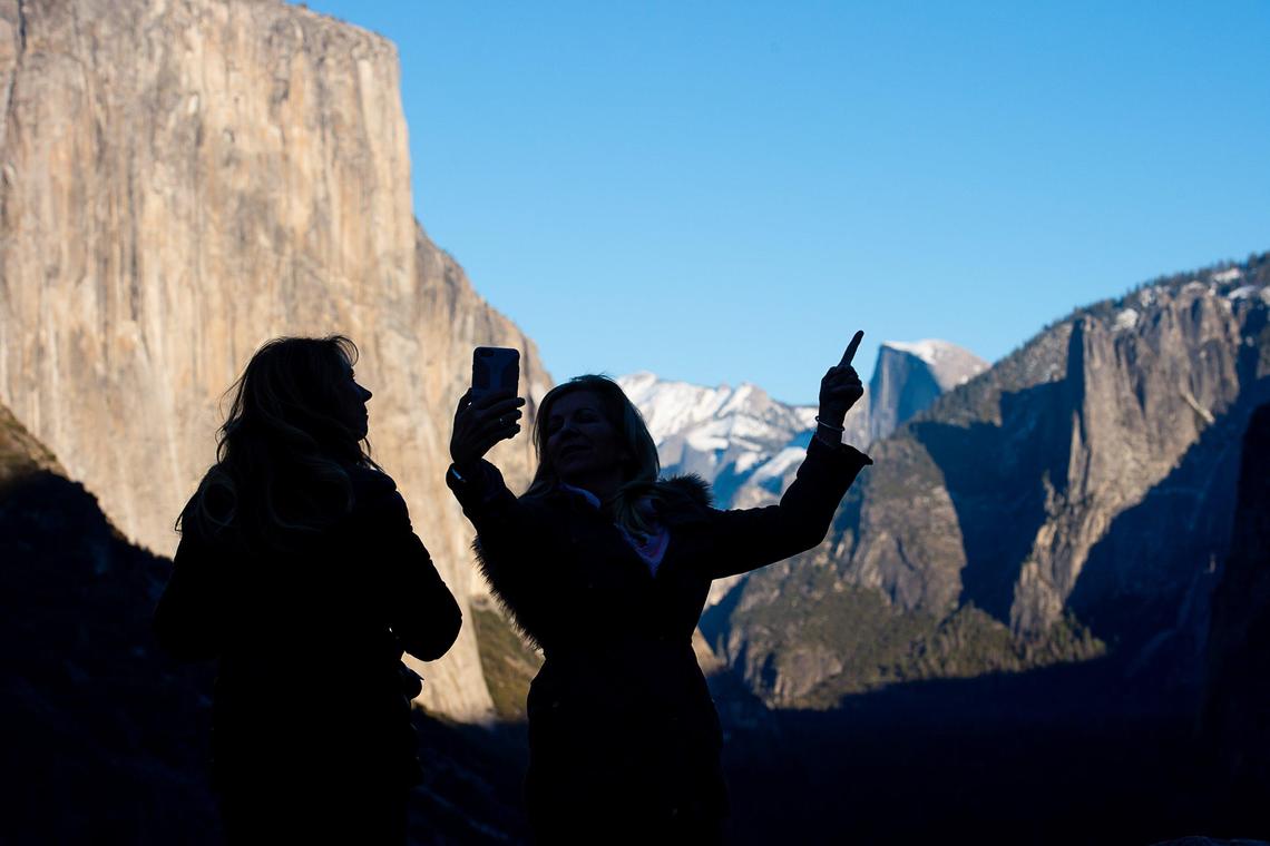 Joanne Pederson and Debbie Furnari of Santa Clarita take a photograph of Yosemite Valley at Yosemite National Park on Wednesday, Jan. 2, 2019. A day after a holiday, and during the federal budget shutdown, Furnari said she “hasn’t seen the park so uncrowded.”