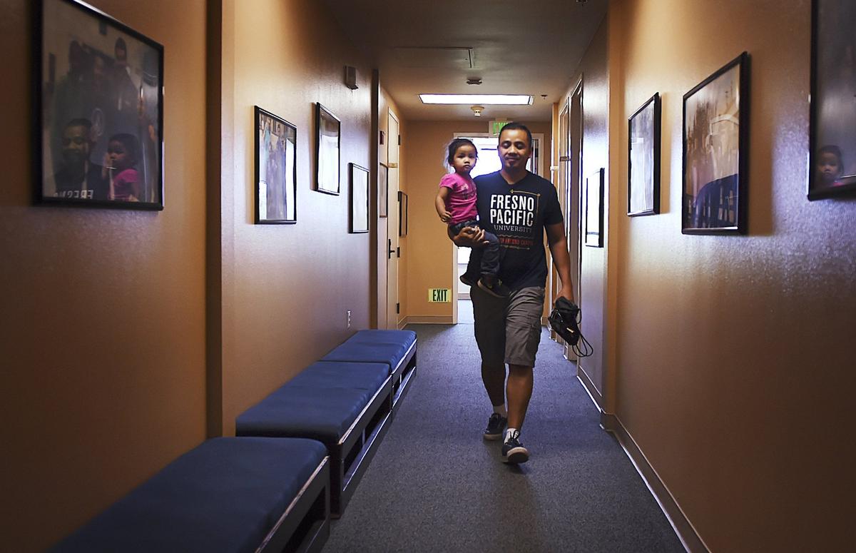 Vanna In carries his daughter Thanny In, 2, at North Fresno Church - Mennonite Brethren on Friday, May 4, 2018.