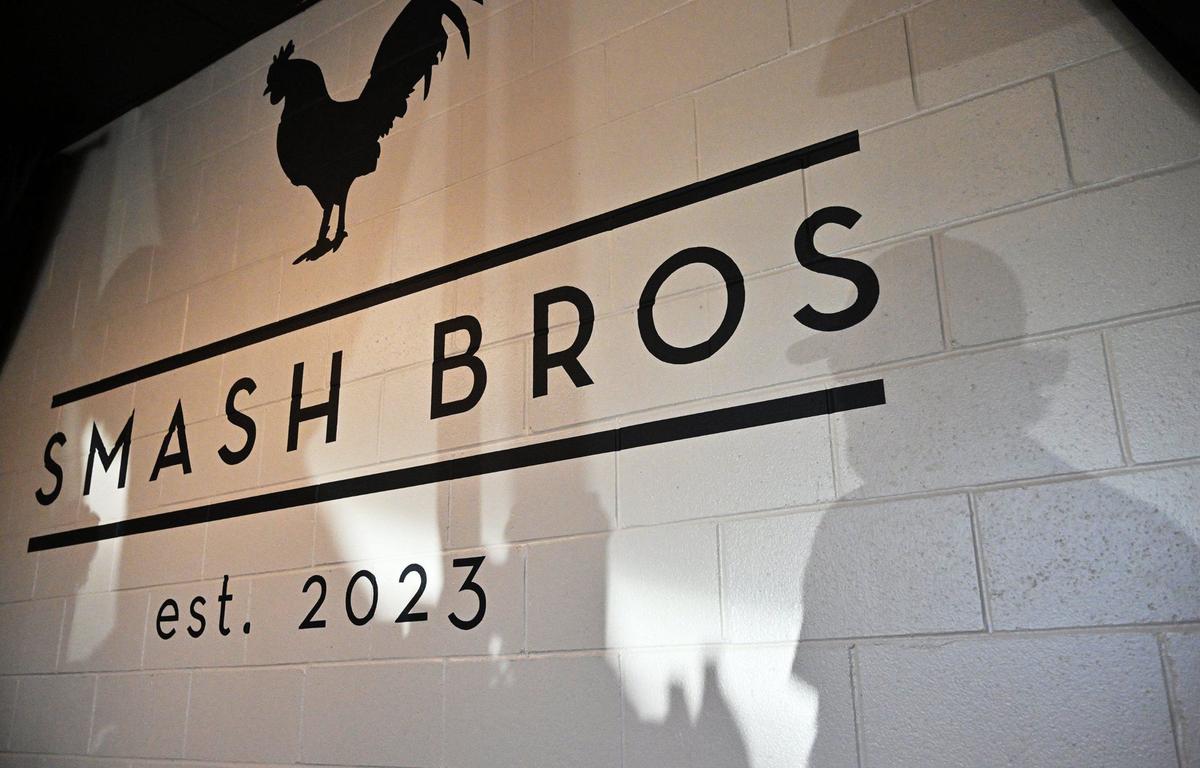 Shadows of customers are seen in line at Smash Bros Bistro.