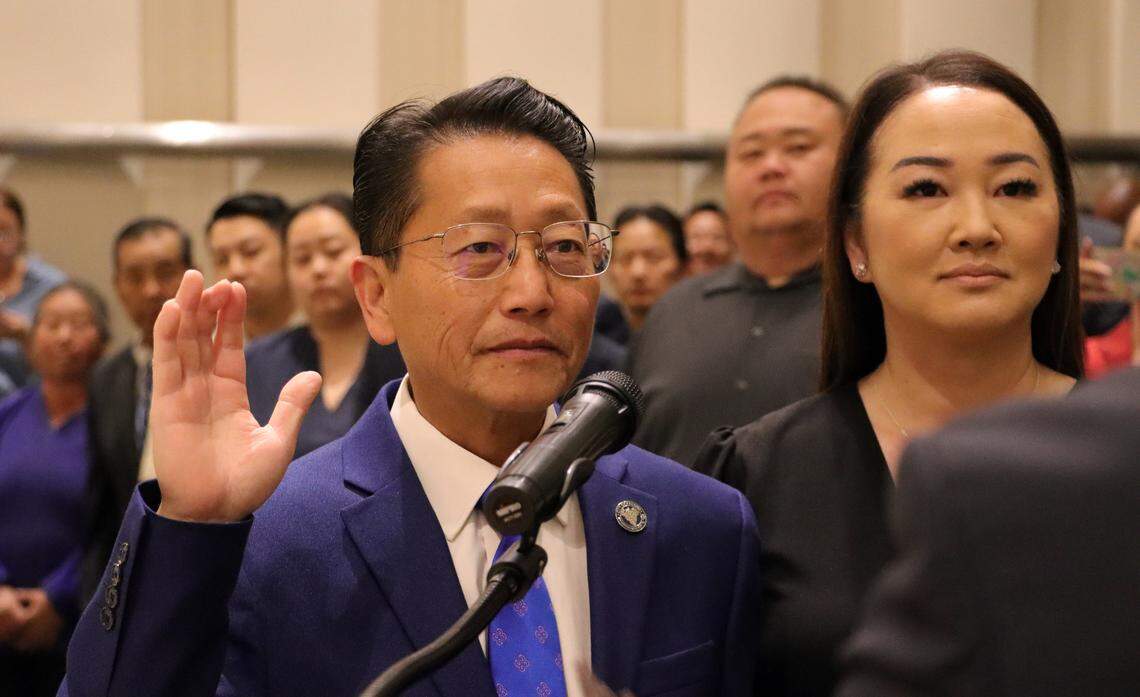 Fresno City Councilmember Brandon Vang, accompanied by his wife, May Lee, takes the oath of office at Fresno City Hall on April 10, 2025. He will serve a two-year term.