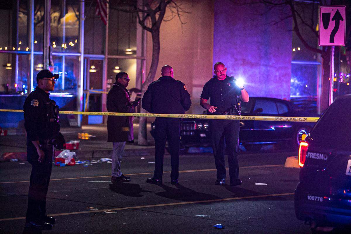 Officers investigate a shooting outside a nightclub that left four people injured on Sunday, Jan. 9, 2022.