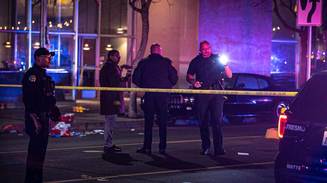 Officers investigate a shooting outside a nightclub that left four people injured on Sunday, Jan. 9, 2022.