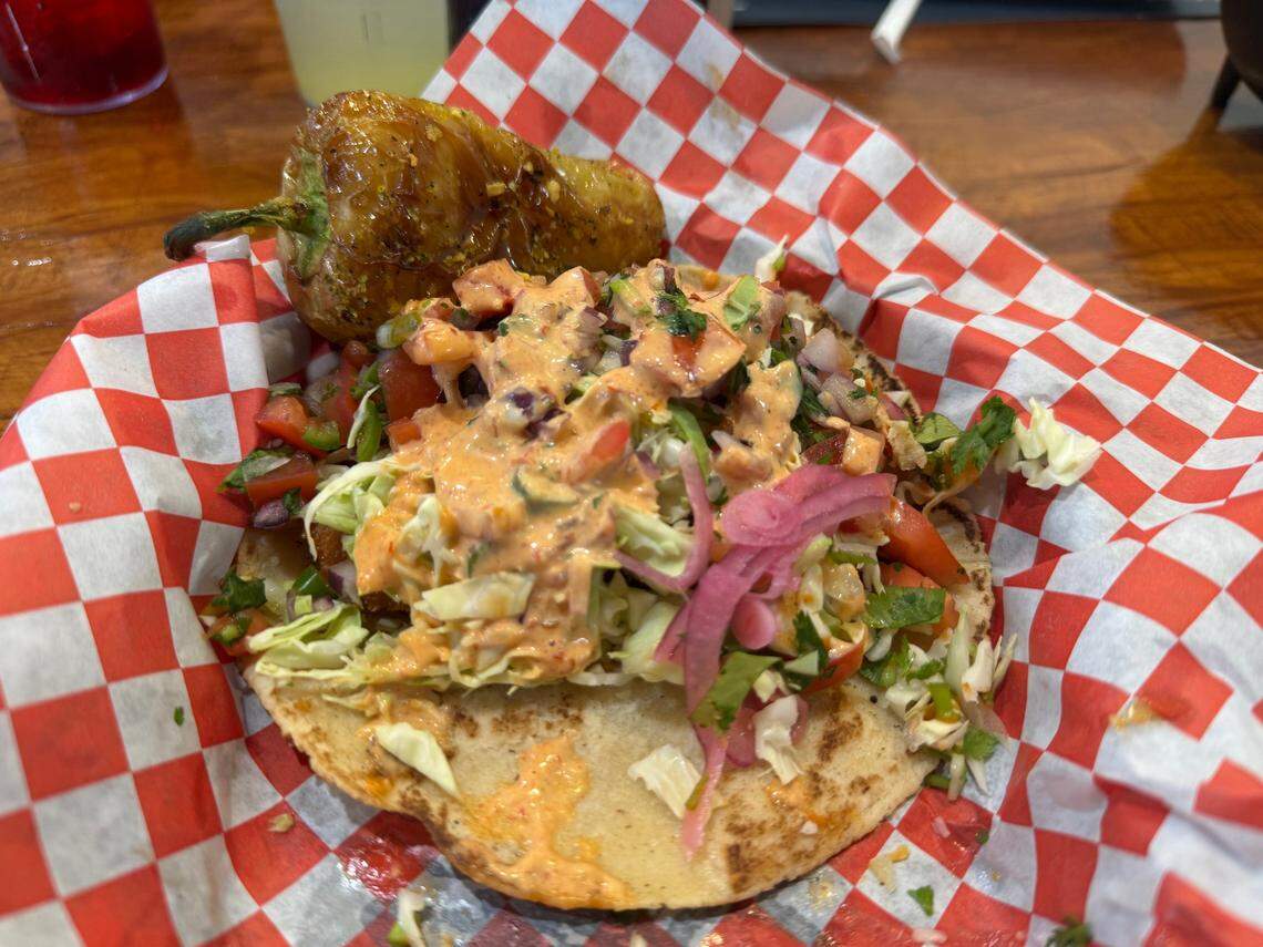 Beer battered Baja shrimp taco with cabbage, pico de gallo and chipotle sauce with a side of fried yellow pepper, lightly seasoned with lemon pepper.