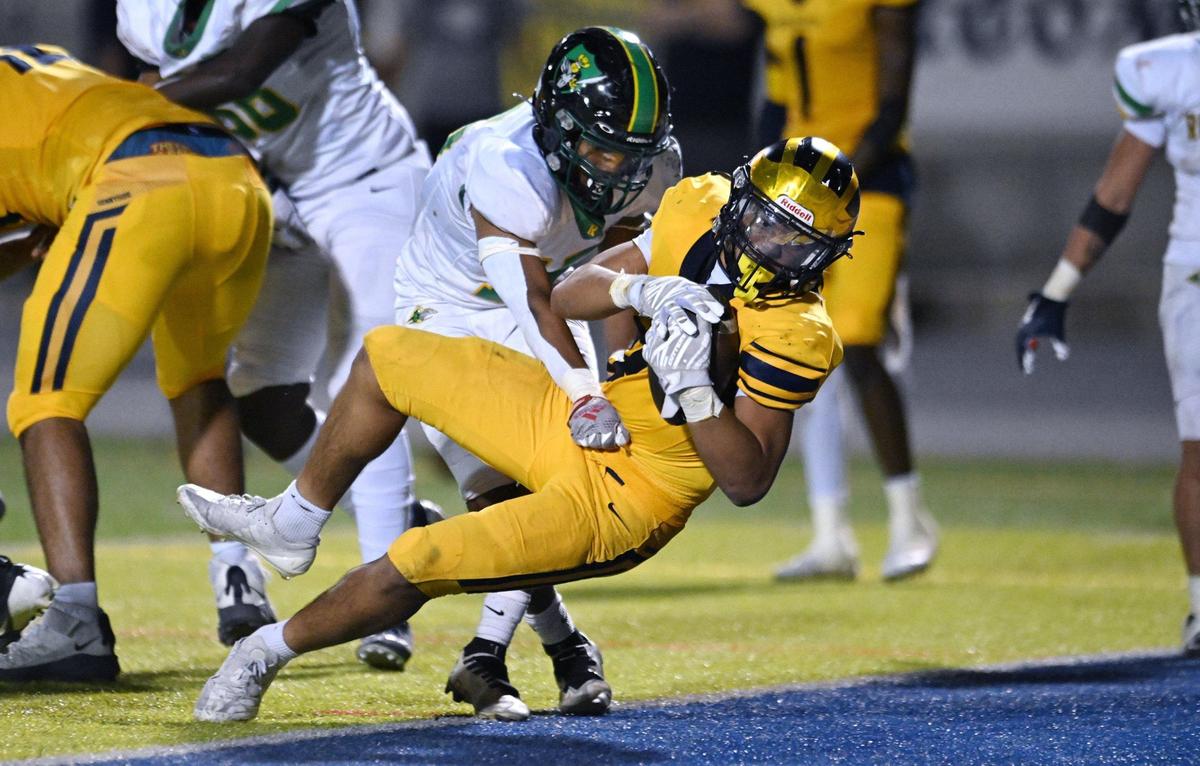 Sunnyside’s Romulan Phetvixay, center, falls into the endzone for a touchdown, making it 35-14 against Roosevelt in the fourth quarter Friday, Oct. 4, 2024 in Fresno.