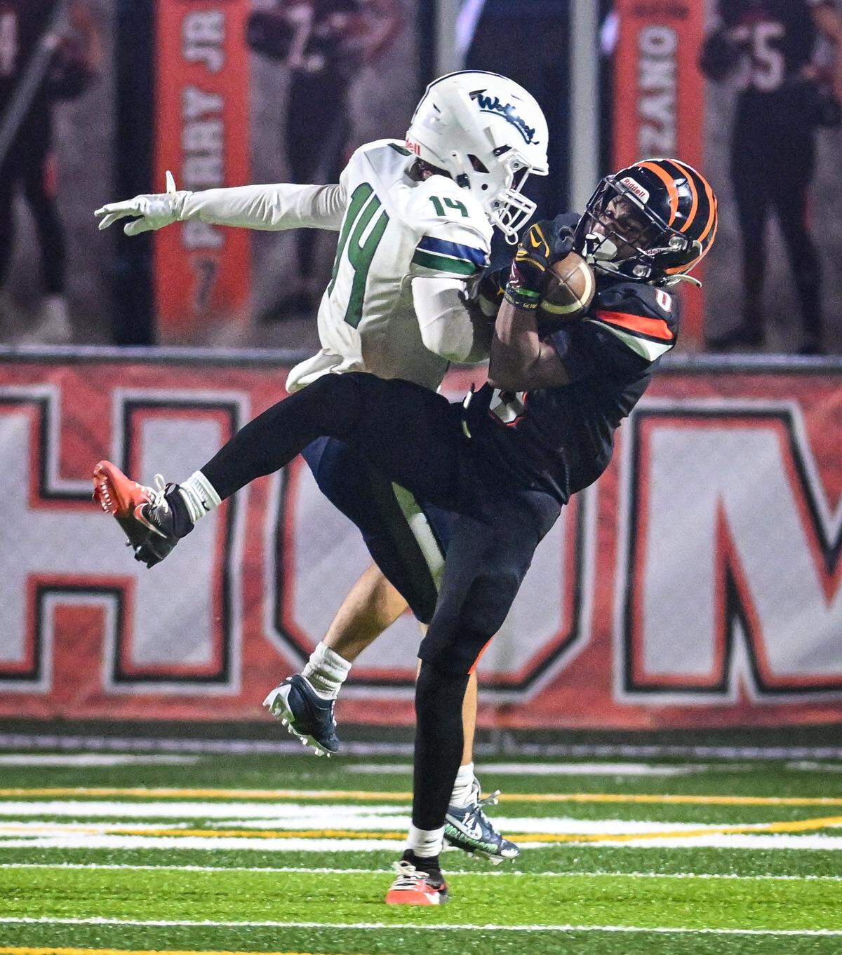 Central East's Xavior Jones, right, intercepts the ball on a pass intended for Clovis East's Elijah Wilson during their playoff game at Deran Koligian Stadium in Fresno on Friday, Nov. 7, 2025.