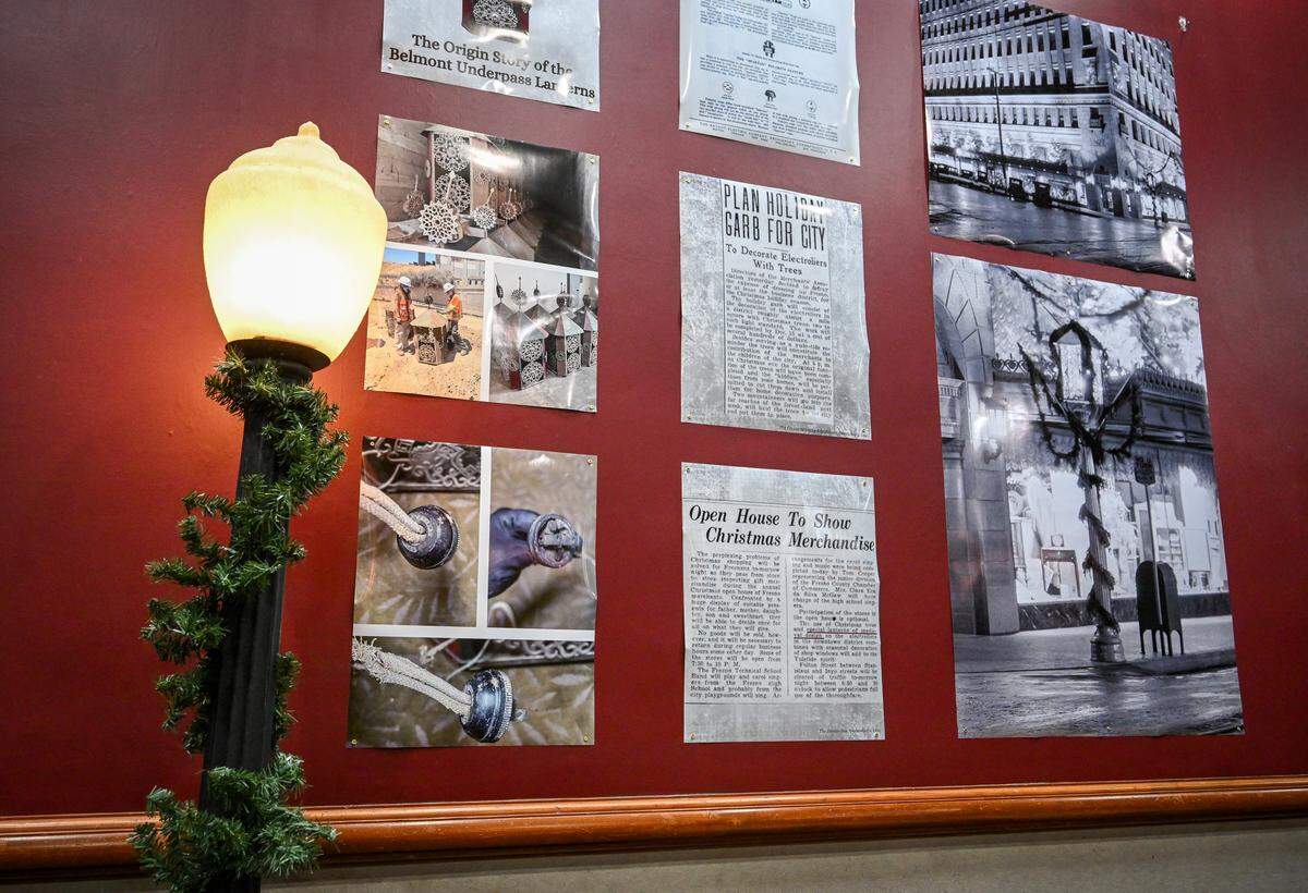A model of a streetlight known as an electrolier stands in front of newspaper articles and photos showing the lanterns found earlier this year by CalTrans workers building the California High-Speed Rail project through Fresno, during a news conference at The Archive on Kern on Friday, Dec. 19, 2025. The Fresno City & County Historical Society was able to uncover the mystery of the lanterns, which had been used to celebrate the holidays in downtown Fresno nearly 100 years ago. A 1929 Pop Laval photo, right, helped reveal the origins of the lanterns.