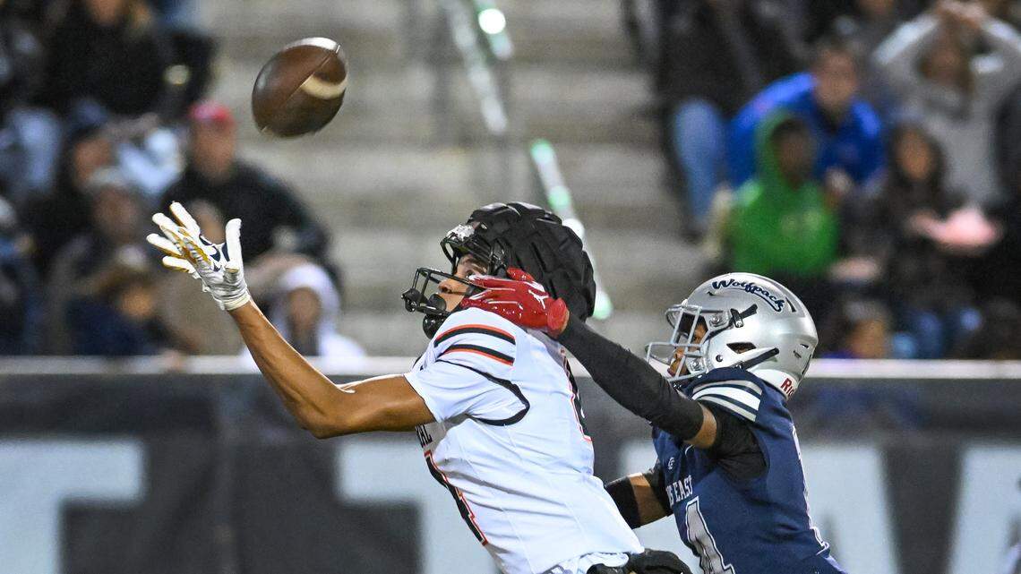 Central’s Zeb White, left, reaches up to catch a pass as he’s covered by Clovis East’s Taevionne Horton during their Central Section Division 1-AA football championship game at Lamonica Stadium on Friday, Nov. 22, 2024.