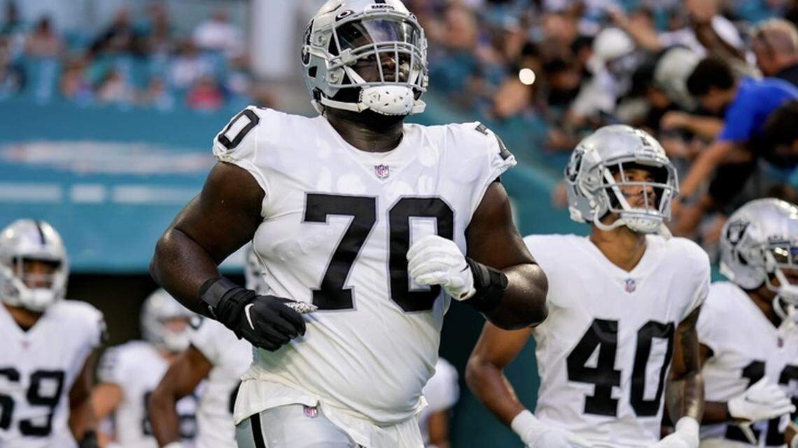 Las Vegas Raiders offensive lineman Alex Leatherwood jogs onto the field at Hard Rock Stadium on Saturday, Aug. 20, 2022.