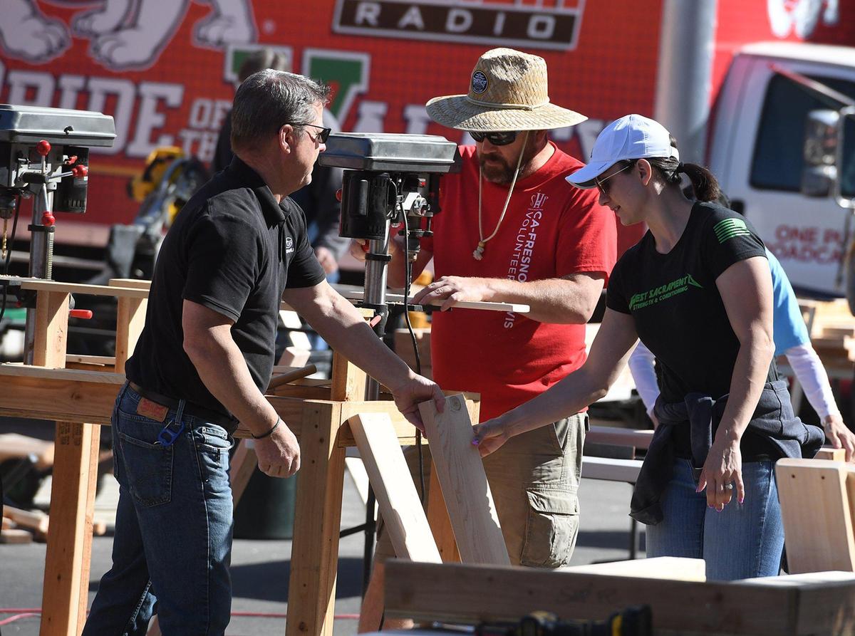 Volunteers prepare frame pieces at the Bunk Bed Build for children in need through the Fresno chapter of Sleep In Heavenly Peace on Saturday, May 8, 2021. One Putt Broadcasting employees helped in creating 10 bunks for kids in the Fresno and Clovis area.