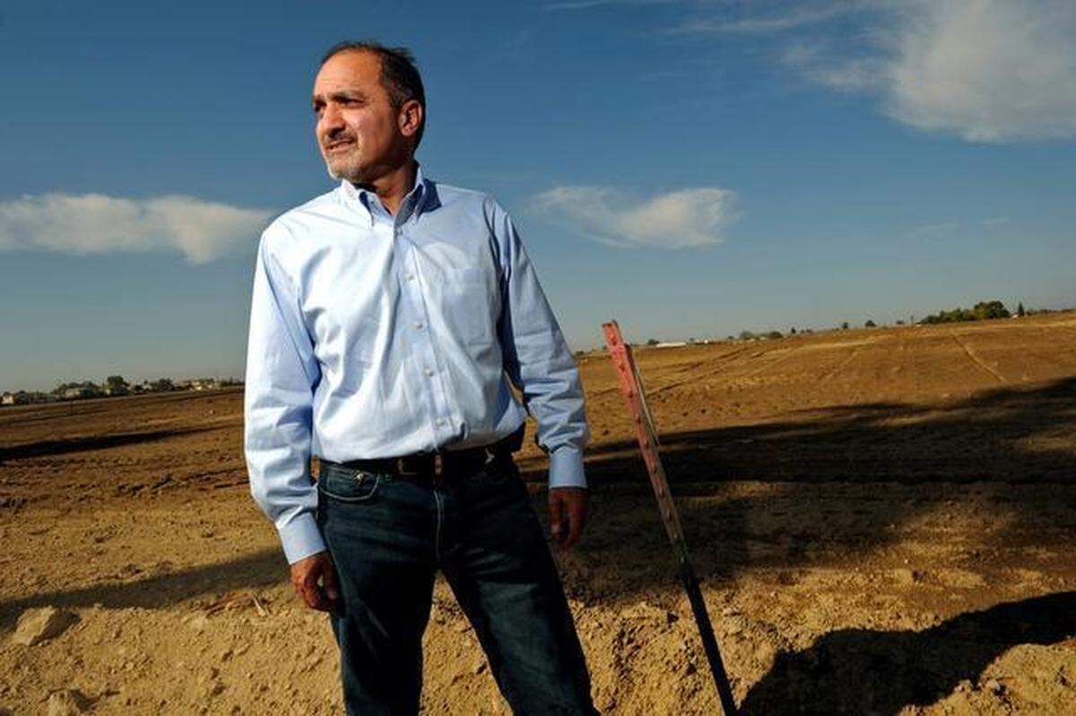 Developer Darius Assemi of Granville Homes stands on the Mission Ranch property west of Highway 99 on Wednesday, Oct. 23, 2013 in Fresno, Calif. Assemi family members had bought the land that year through one of their farming LLCs and were allowed to grow crops on the residentially-zoned space by the Fresno City Council. Granville Homes said then that it hoped to build housing on the land in the long-term.