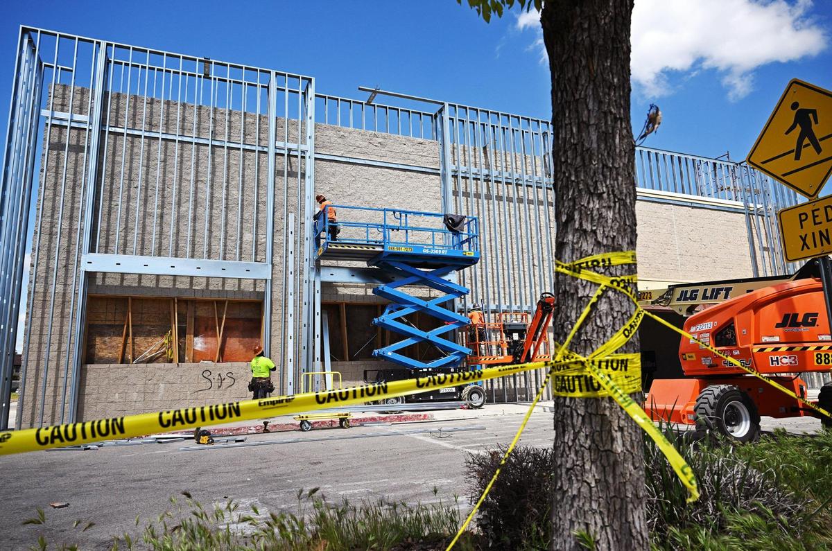 Two new businesses have signed a lease for the former Walmart on West Shaw Avenue as construction workers work on the sprawling structure near Brawley Avenue in Fresno.