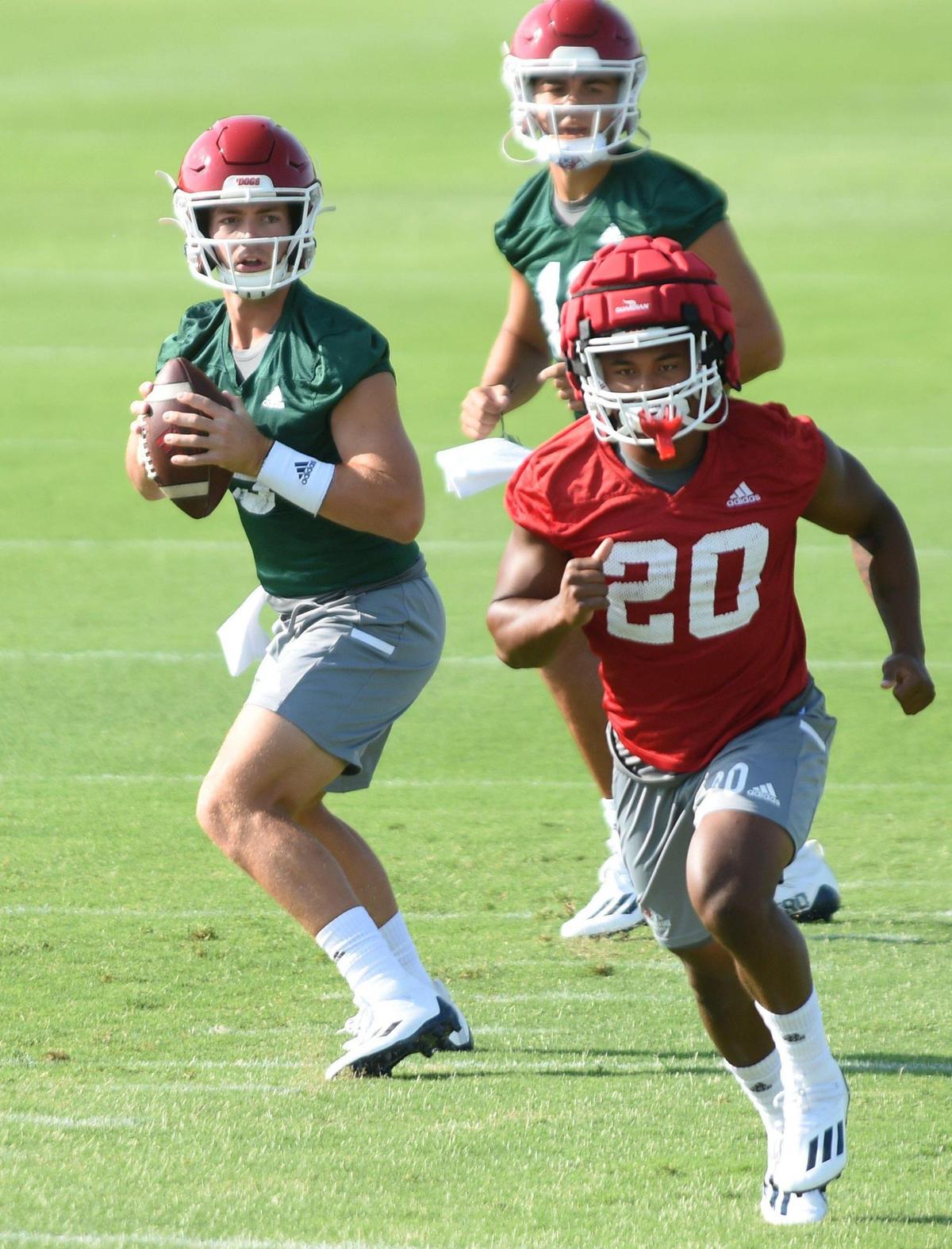 Fresno State quarterback Jake Haener looks downfield as running back Ronnie Rivers runs his route during the first day of fall practice, July 30, 2021.
