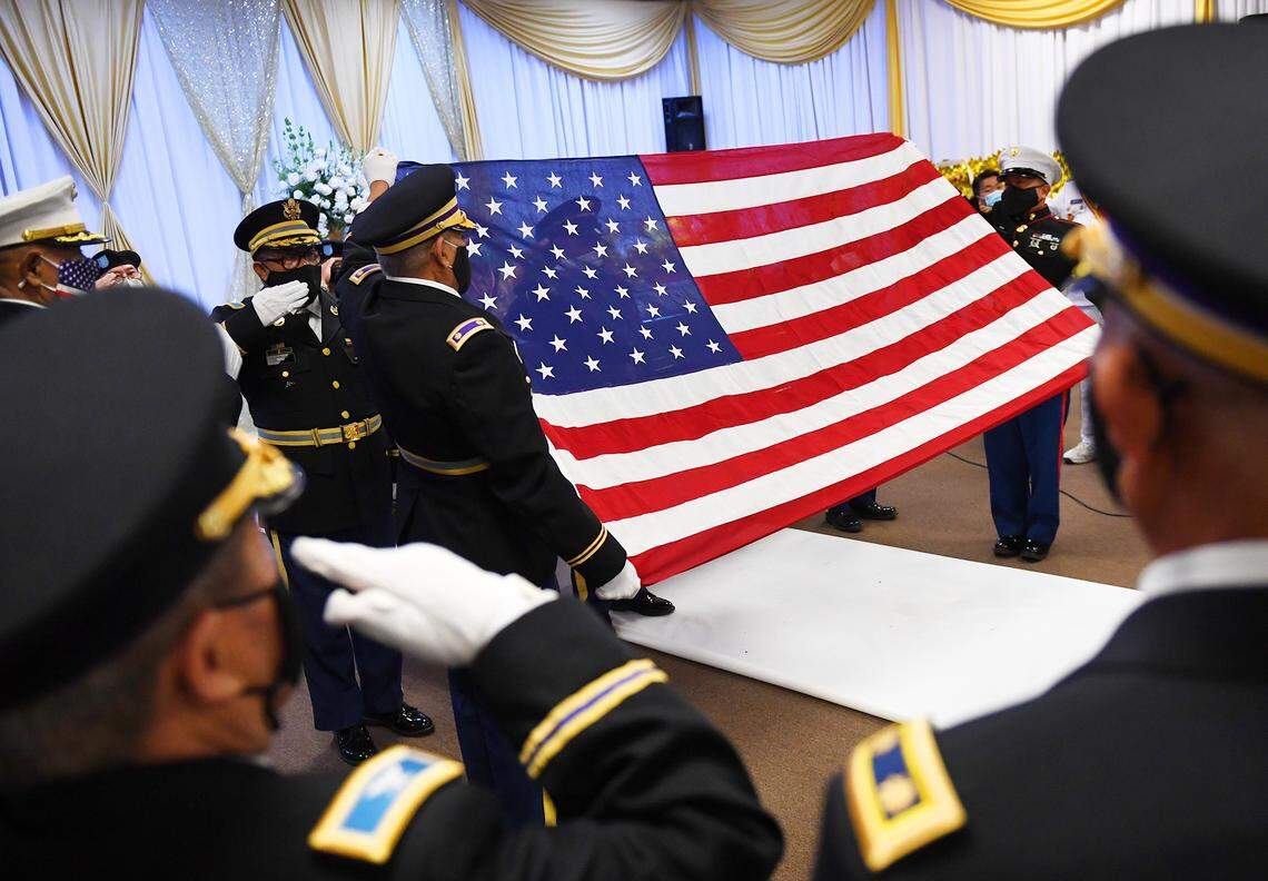 The flag is prepared to be draped over the casket of Col. Wangyee Vang, Ph.D, on the first of the three-day memorial service Saturday morning, March 13, 2021 in Fresno. Vang was the leader of the Laos Veterans of America and served in the U.S. Secret Army during the Vietnam War.
