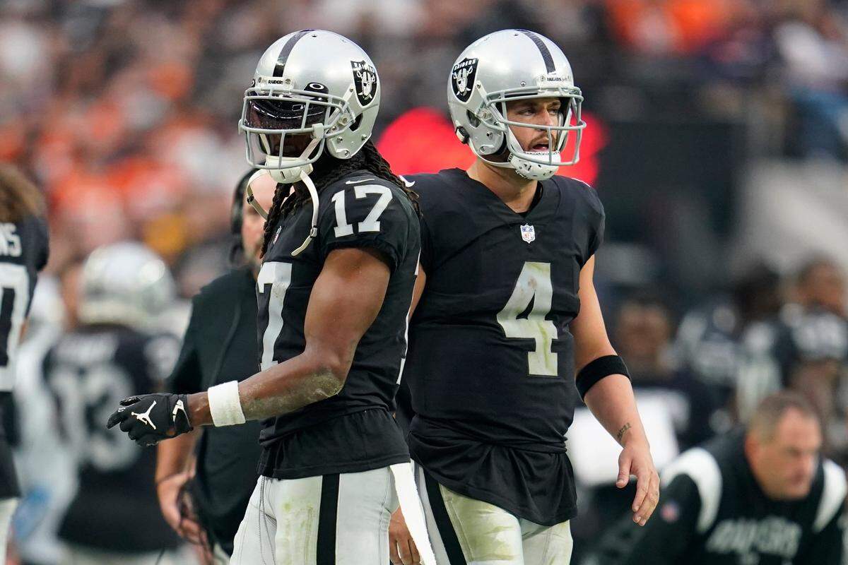 Las Vegas Raiders wide receiver Davante Adams, left, and quarterback Derek Carr, right, look on from the sidelines during the second half of an NFL game against the Denver Broncos, Sunday, Oct. 2, 2022 in Las Vegas.