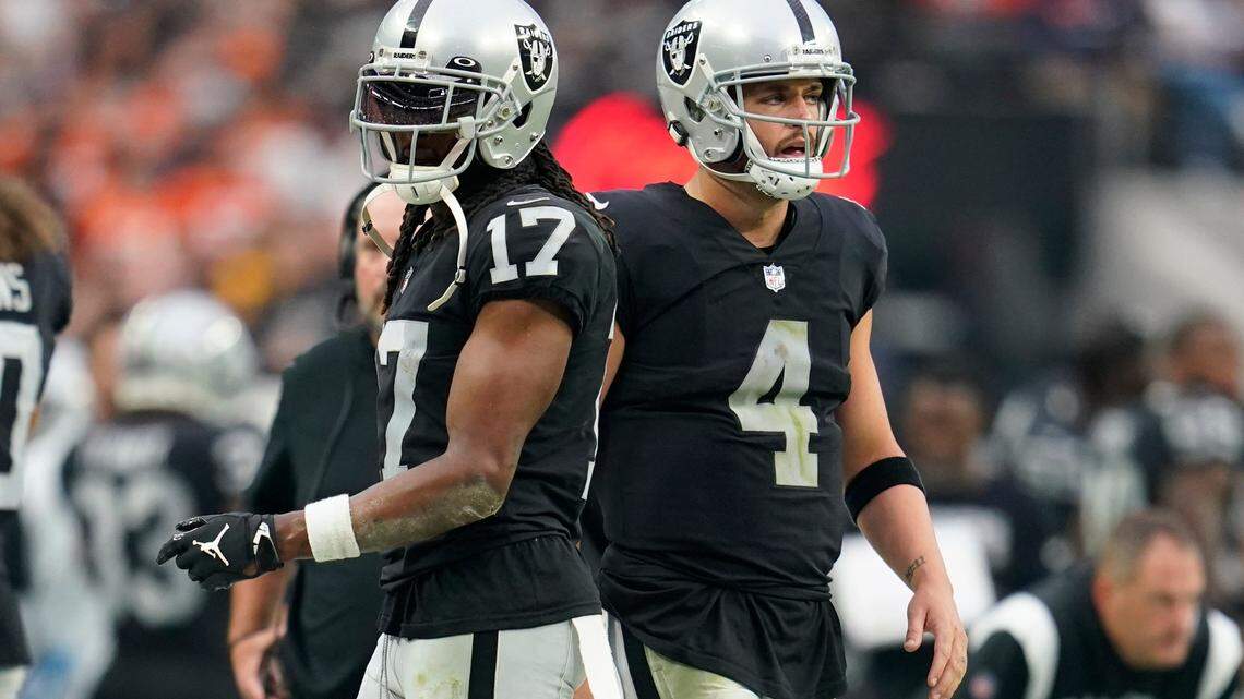 Las Vegas Raiders wide receiver Davante Adams, left, and quarterback Derek Carr, right, look on from the sidelines during the second half of an NFL game against the Denver Broncos, Sunday, Oct. 2, 2022 in Las Vegas.