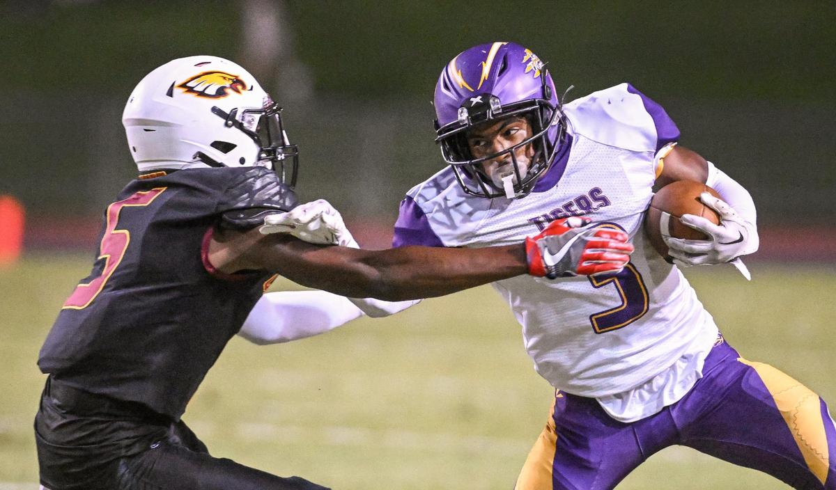 Lemoore’s Kobe Green tries to get around Clovis West’s Marshel Sanders on a run to the sideline during their game at Veterans Memorial Stadium on Friday, Sept. 1, 2023.