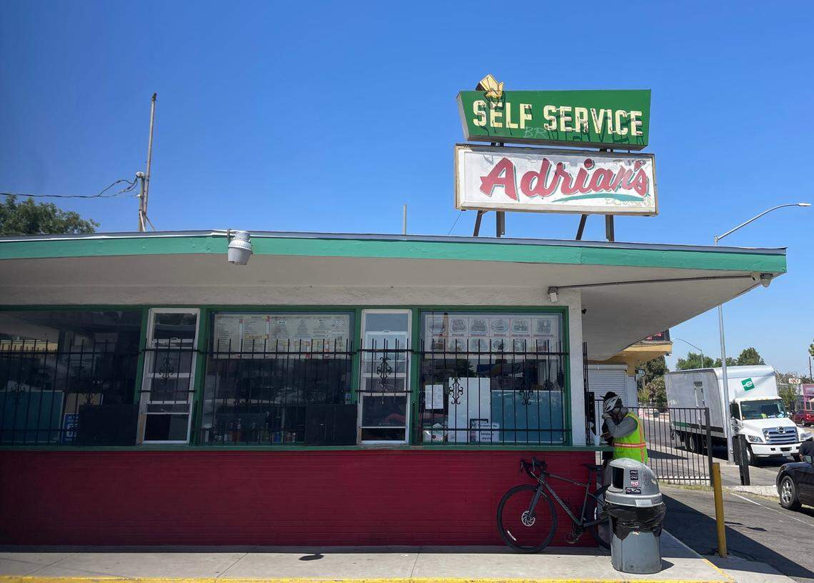 Pete Gonzalez, right, eats a chile verde burrito and beef taco at the counter at Adrian’s on Belmont Avenue in Fresno on Thursday, June 21, 2024.