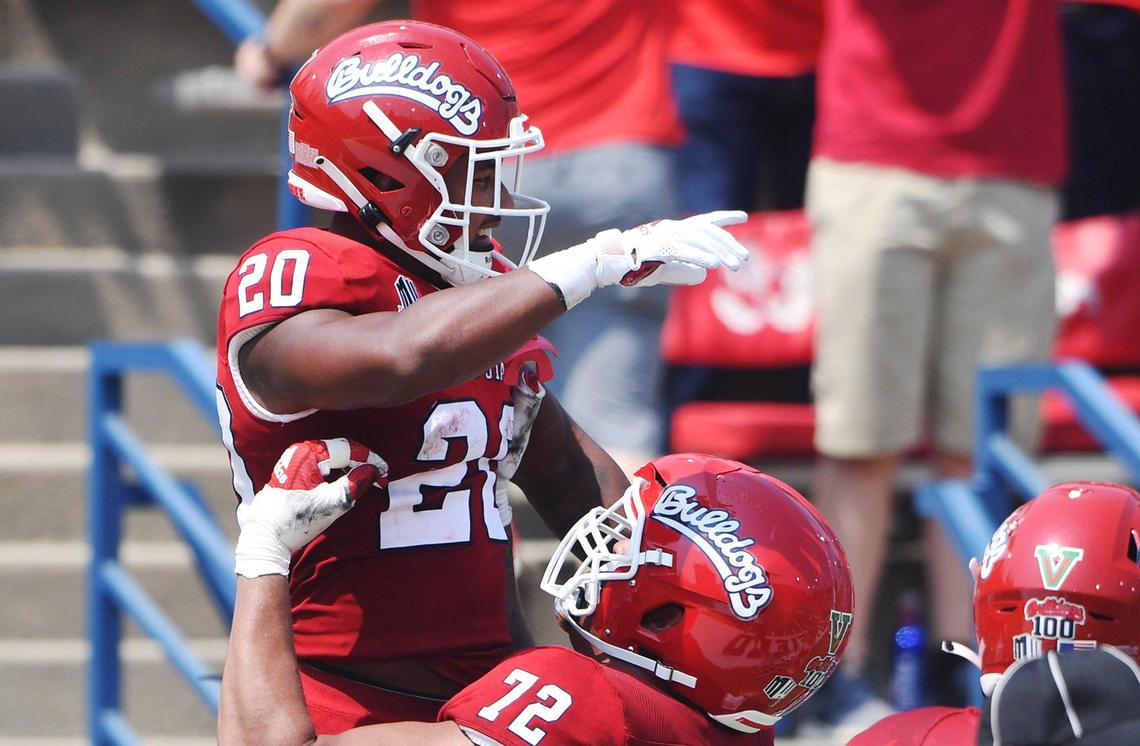 Fresno State running back Ronnie Rivers gets a lift from tackle Dontae Bull after scoring a touchdown in the Bulldogs season-opener against UConn. Rivers became the school’s career TD leader on the play, Saturday, Aug. 28, 2021 in Fresno.