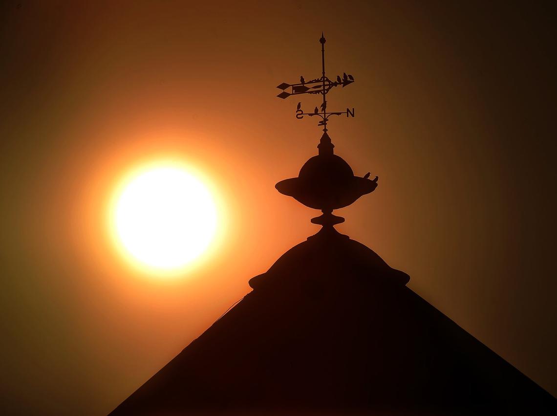 The sun sets over the Fresno Watertower in downtown, through smoky air from the Camp Fire, Friday afternoon, Nov. 16, 2018.