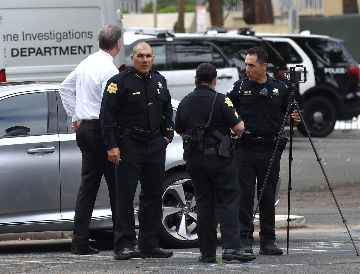 Fresno Police Chief Paco Balderrama confers with officers after a man was shot and killed on Tuesday, after police say he attacked a detective in his office at the Fresno Police Department Headquarters. The incident happened just before noon at the department’s Annex building off of Fresno Street.