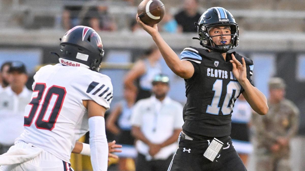 Clovis North quarterback Mario Cosma, right, throws while getting pressure from Memorial’s Mateo Peracchi during their game at Veterans Memorial Stadium in Clovis on Friday, Aug. 18, 2023.