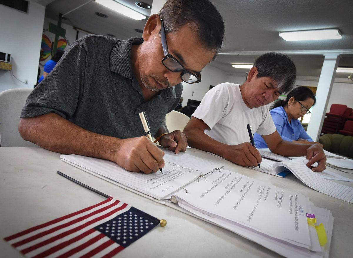 Silath Saopadith, left, with Bounnhing Souvonnavong, center, and Sovanny Ouk, right, work on a lesson during their citizenship and civics class at the Fresno Interdenominational Refugee Ministries, which works with ethnic communities from Laos, Cambodia and the Syrian refugees, Wednesday Aug. 22, 2018.