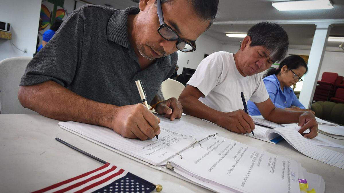 Silath Saopadith, left, with Bounnhing Souvonnavong, center, and Sovanny Ouk, right, work on a lesson during their citizenship and civics class at the Fresno Interdenominational Refugee Ministries, which works with ethnic communities from Laos, Cambodia and the Syrian refugees, Wednesday Aug. 22, 2018.