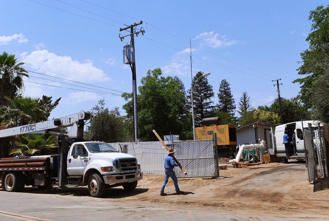 A Madera County Public Works team with help from a contractor repairs a broken pump on the Fender water well Thursday, June 17, 2021 in Madera Ranchos. Water is a critical source, compounded by housing developments in the area.