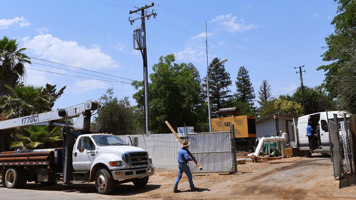 A Madera County Public Works team with help from a contractor repairs a broken pump on the Fender water well last June in Madera Ranchos. Water is a critical source, compounded by housing developments in the area.
