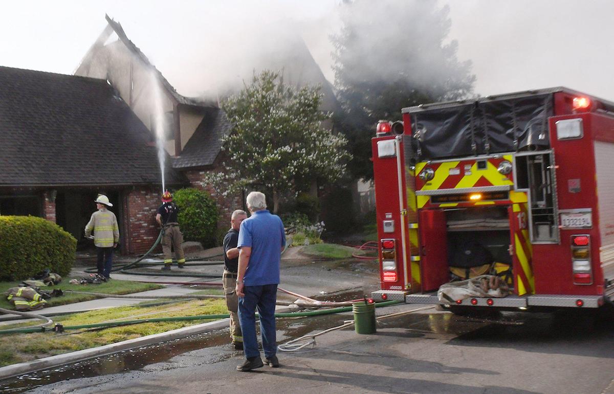 Firefighters responded to a fire at a home in northwest Fresno that quickly spread to an adjacent house Monday, July 26, 2021 in Fresno, California.