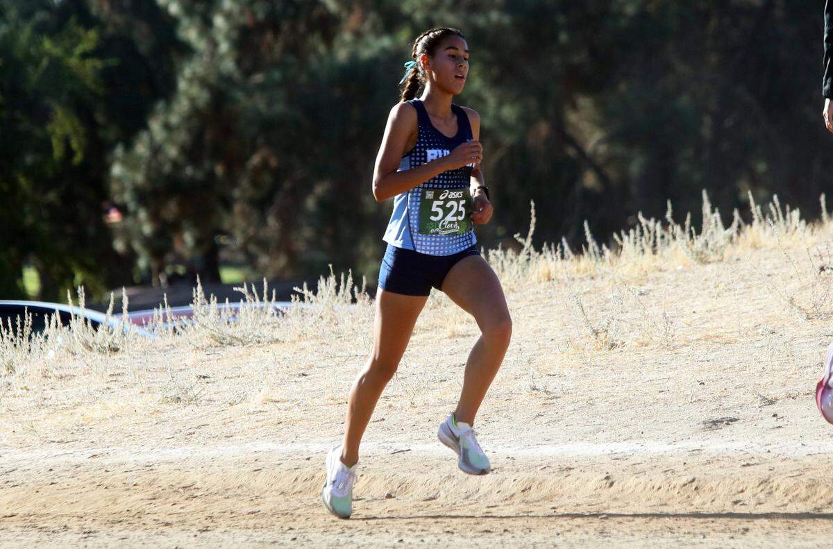 Bullard High junior Isabella Ramírez placed eighth overall (17:25.2) in the Bill Buettner race of the 2024 Asics Clovis Cross Country Invitational at Woodward Park on Oct. 12, 2024.