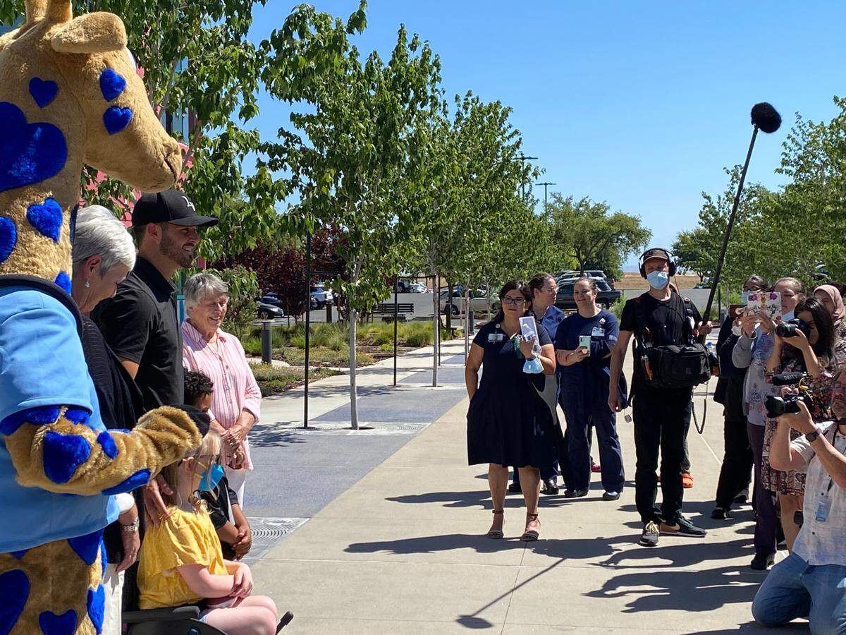 Former Fresno State football star and current Las Vegas Raiders quarterback Derek Carr takes a photo with staff and patients during a celebration of the opening of the newly renovated children’s playground at Valley Children’s Hospital on Friday, June 10, 2022.