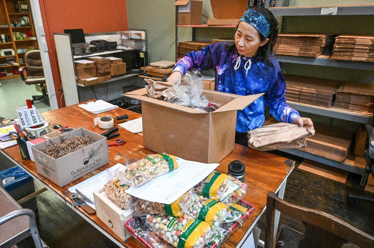 Yan Jiang packages products to be shipped out at the Sierra Nut House’s new location on Pollasky Avenue in Old Town Clovis.