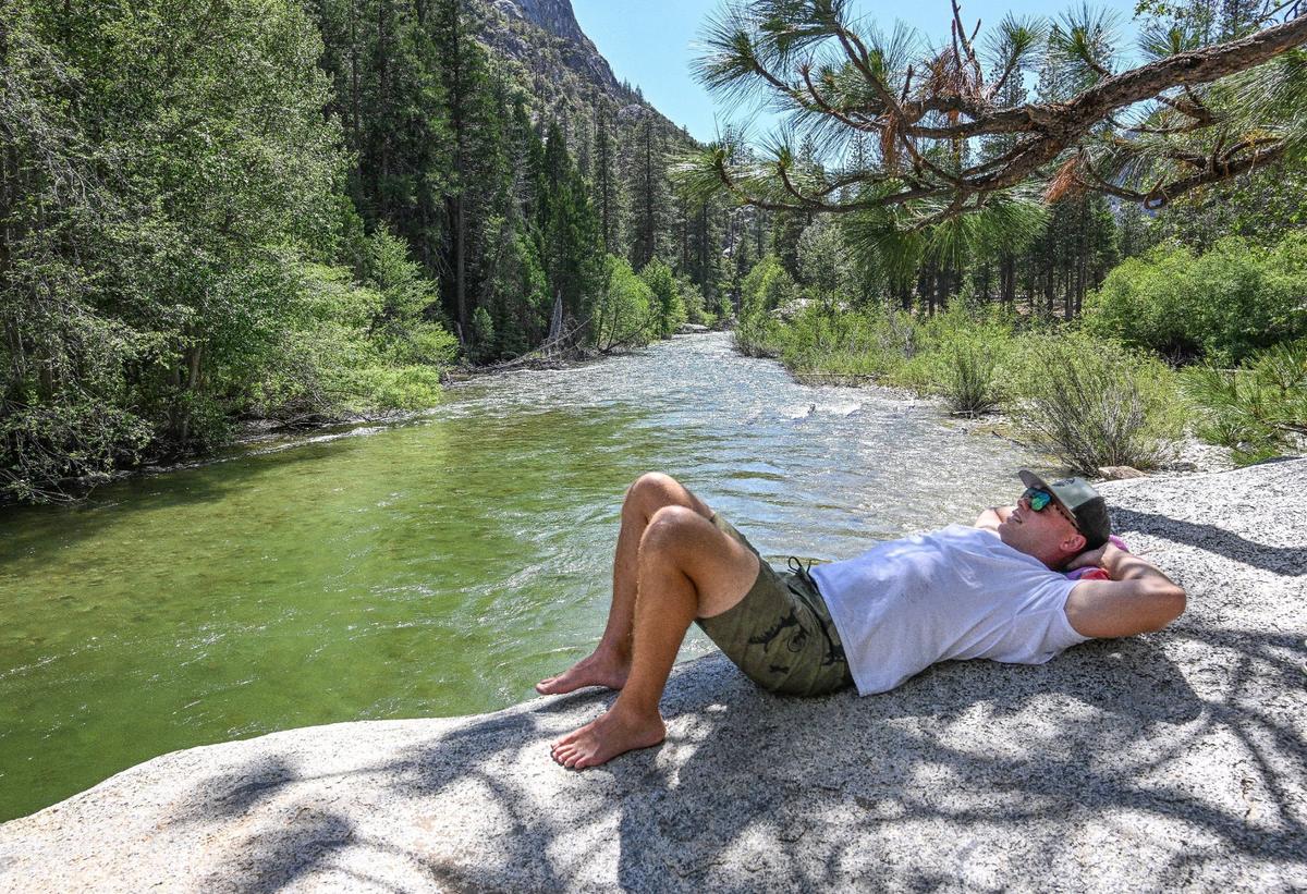 Andrew Guldin of Wichita Falls, Texas relaxes on the edge of Muir Rock on the south fork of the Kings River in Kings Canyon National Park’s Cedar Grove on Tuesday, June 11, 2024.